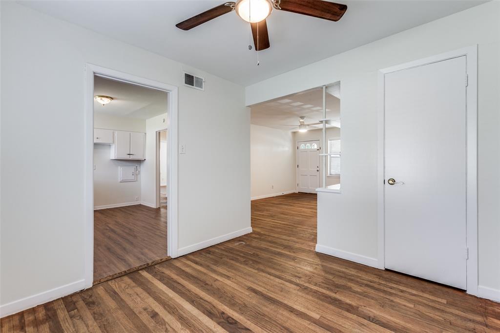10815 Ruth Ann Drive Dallas, TX 75228 - Photo 5 of 12 wooden floor in an empty room with a kitchen