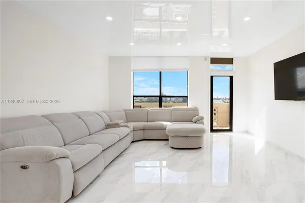 a living room with furniture and a flat screen tv
