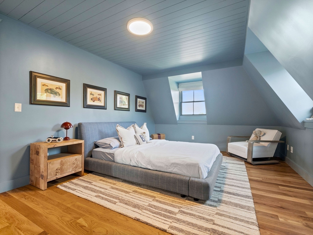 1 Gilbert Road Natick, MA 01760 - Photo 30 of 42 a bedroom with a bed and wooden floor