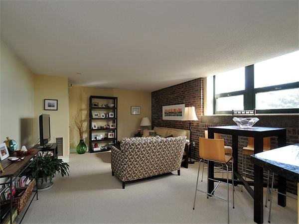 42 8th Street, Unit 5308 Boston, MA 02129 - Photo 2 of 12 a living room with furniture a window and a flat screen tv