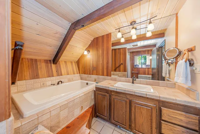 a bathroom with a sink a bathtub and window