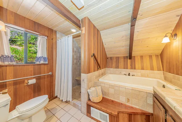 a living room with furniture a table and a projector screen