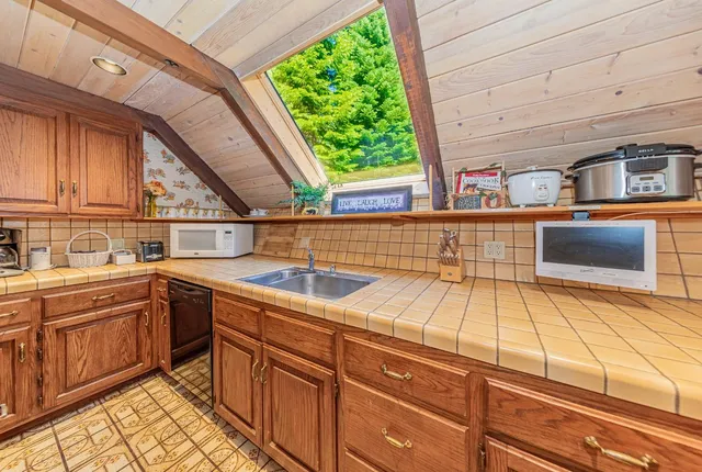 a open kitchen with stainless steel appliances granite countertop a stove and cabinets