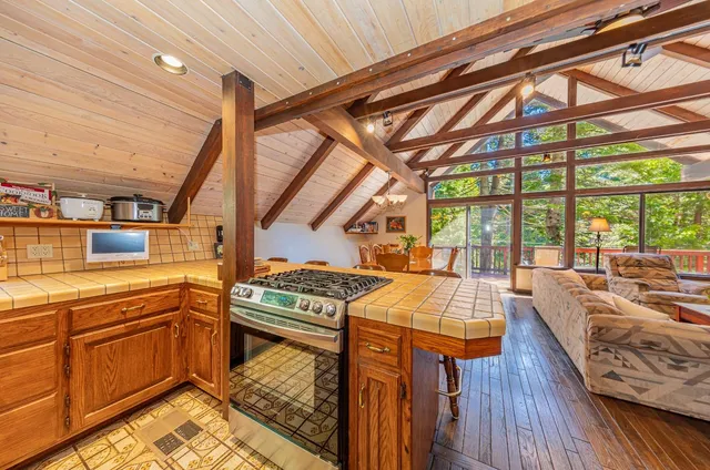 a kitchen with stainless steel appliances granite countertop a sink and a stove