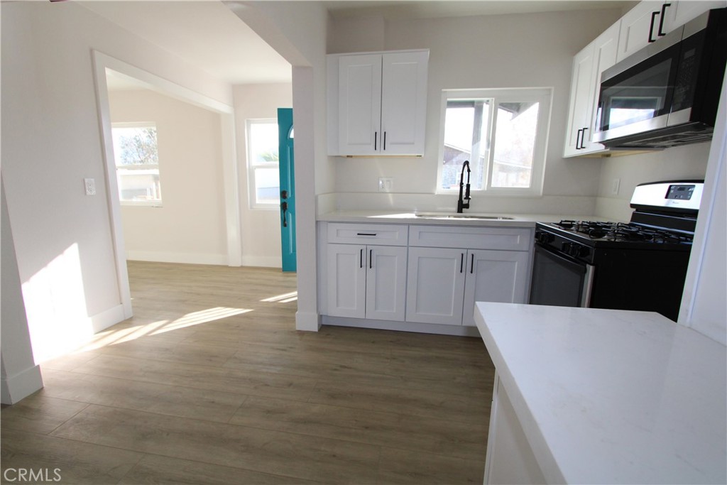 906 North Allen Street Banning, CA 92220 - Photo 2 of 6 a kitchen with a sink a stove and cabinets