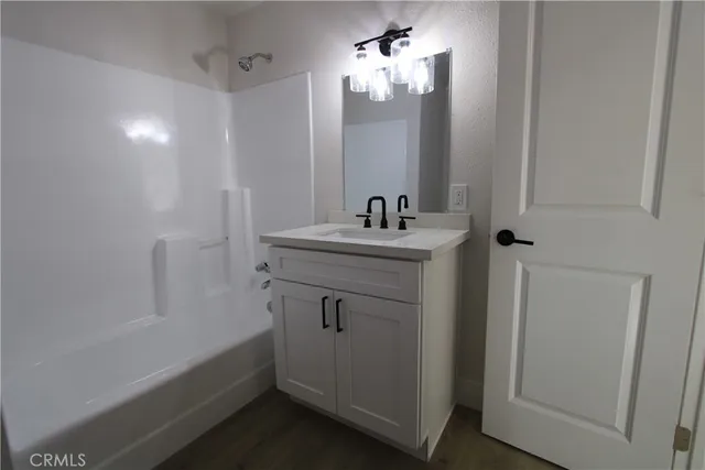 a bathroom with a sink a light fixture a vanity and a mirror