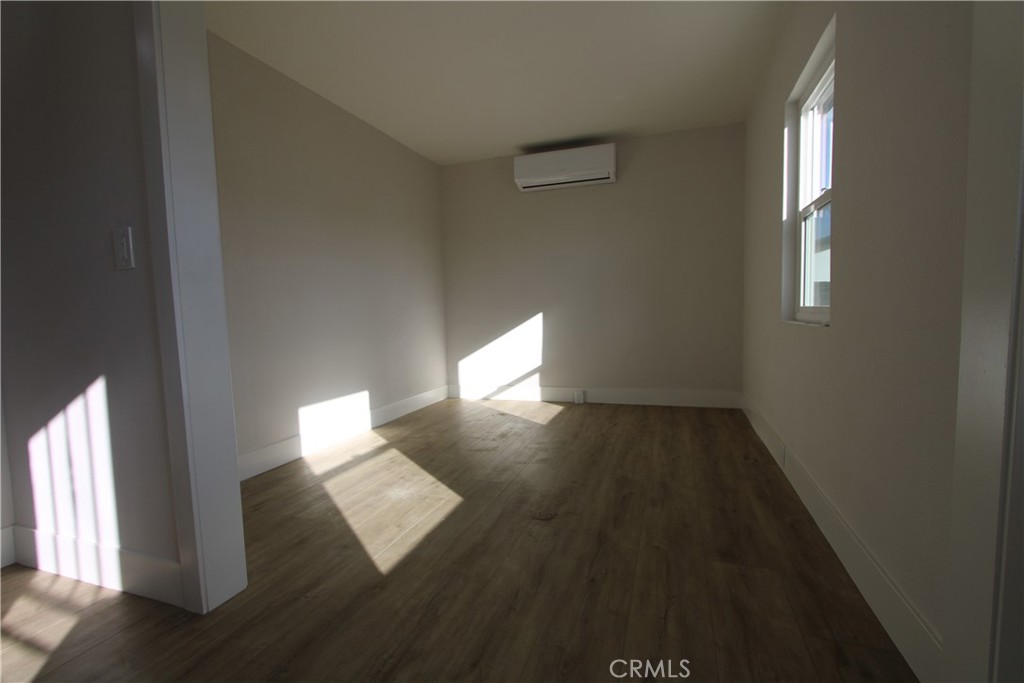 906 North Allen Street Banning, CA 92220 - Photo 6 of 6 an empty room with wooden floor and windows