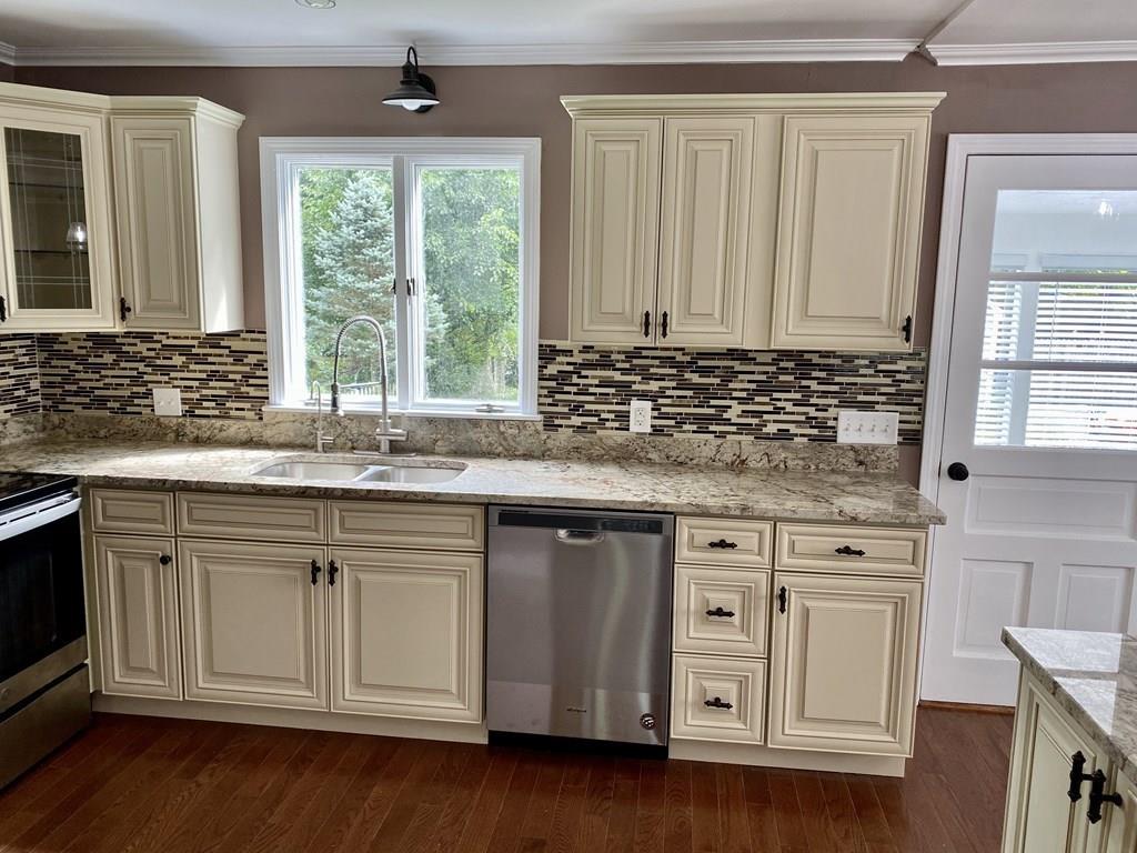 458 Gleasondale Road Stow, MA 01775 - Photo 3 of 14 a kitchen with stainless steel appliances granite countertop a sink stove and cabinets