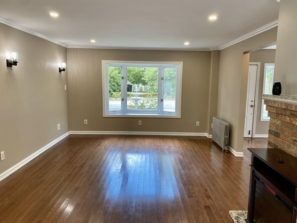 458 Gleasondale Road Stow, MA 01775 - Photo 4 of 14 a view of an empty room with wooden floor and a window