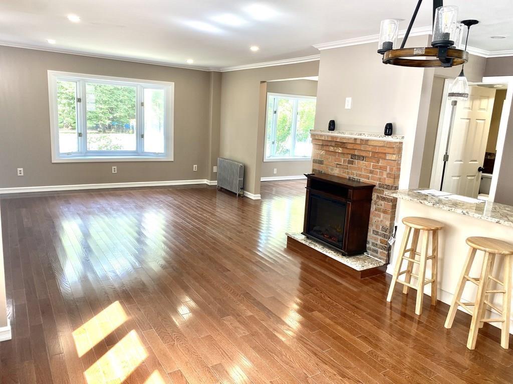458 Gleasondale Road Stow, MA 01775 - Photo 7 of 14 a view of an empty room with wooden floor fireplace and a window