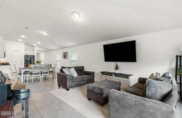 a spacious bedroom with a bed and a flat screen tv