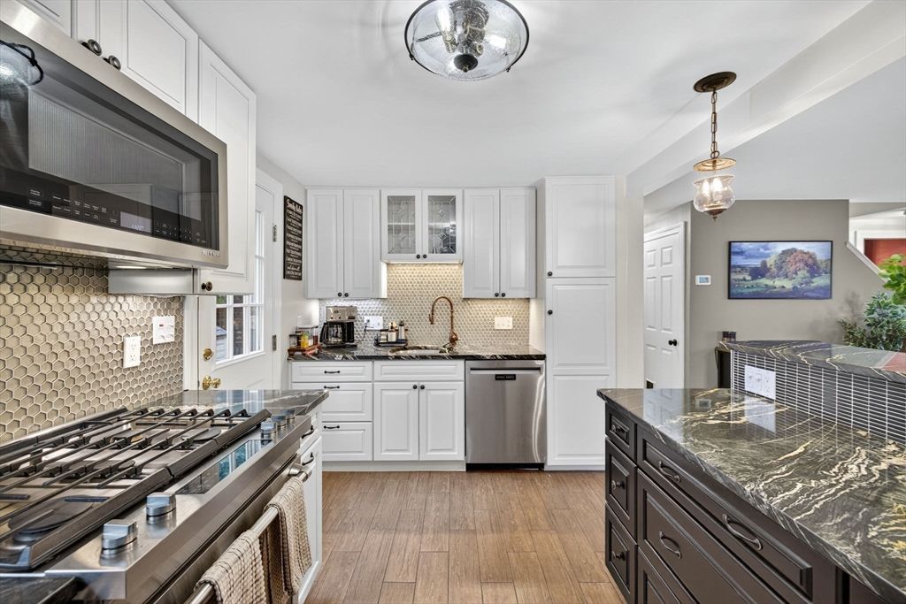 14 Ferndale Road Natick, MA 01760 - Photo 11 of 33 a kitchen with stainless steel appliances granite countertop a stove and a sink
