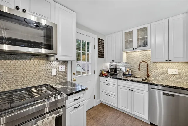a kitchen with granite countertop a stove and a sink