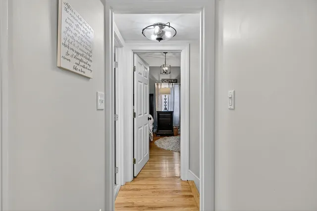 a view of a hallway with wooden floor and a hallway