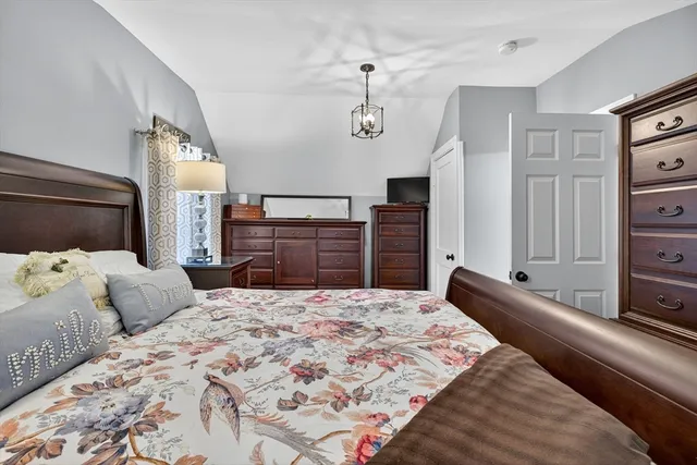 a bedroom with a large bed and dresser