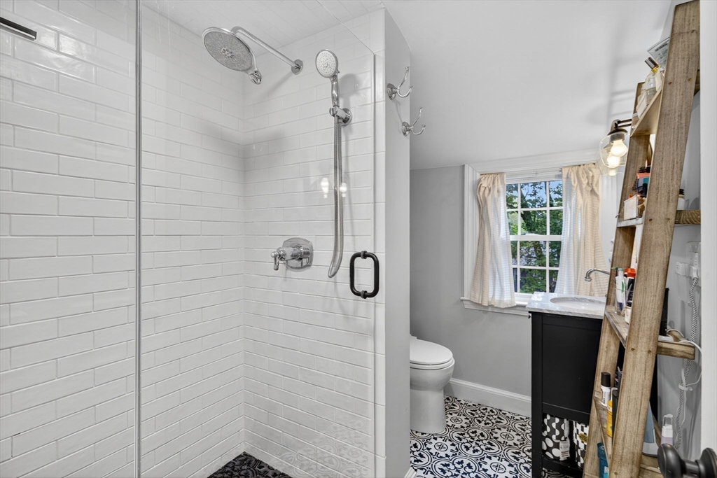 14 Ferndale Road Natick, MA 01760 - Photo 31 of 33 a bathroom with a granite countertop shower a toilet and a window