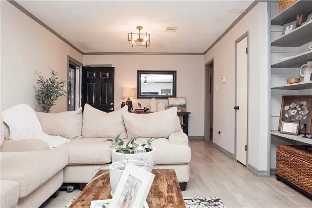 a living room with furniture and wooden floor