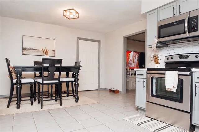 a view of kitchen with cabinets and window