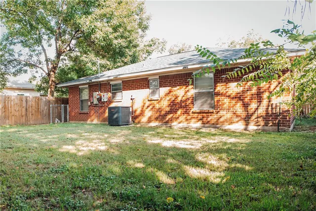 a backyard of a house with barbeque oven and seating space