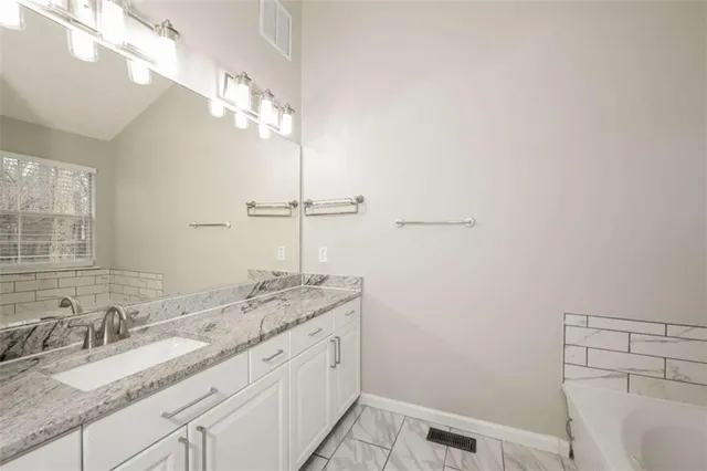 a bathroom with a bathtub and a shower