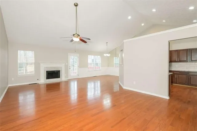 a view of a room with wooden floor and windows