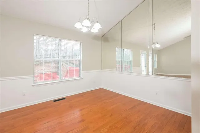 a kitchen with granite countertop wooden cabinets and stainless steel appliances