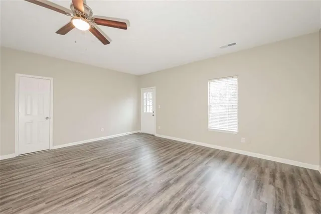 wooden floor in an empty room with a window