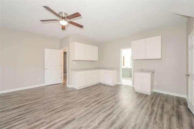 a view of a big room with closet and chandelier fan