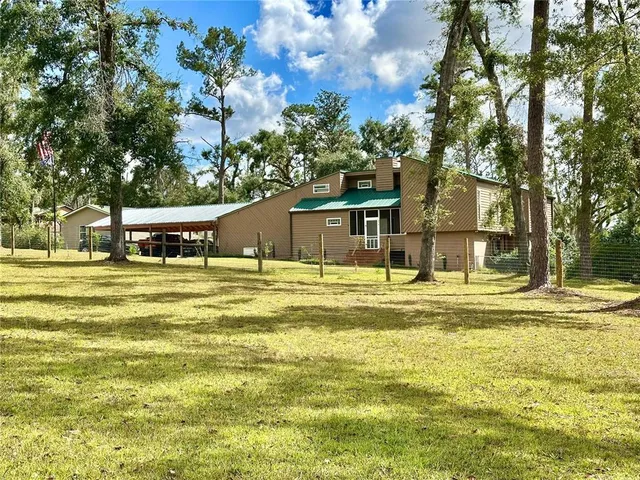 a house view with swimming pool in front of it