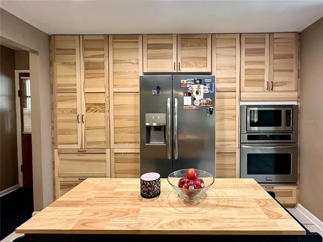 a kitchen with cabinets and window