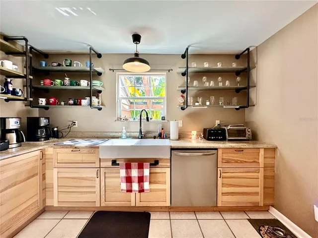 a kitchen with stainless steel appliances granite countertop a refrigerator a stove and a sink