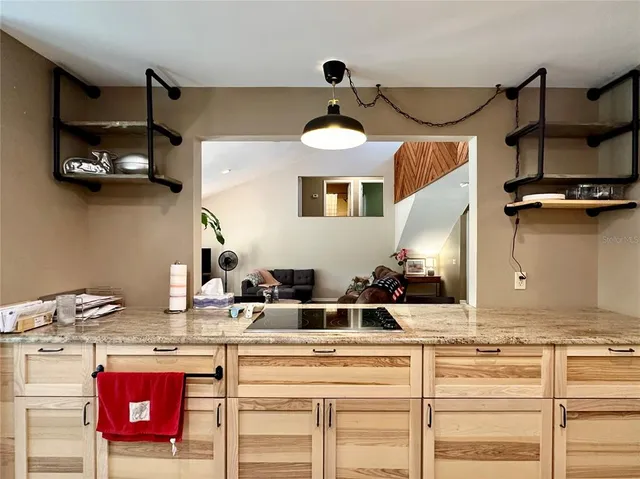 a view of a room with wooden floor and furniture