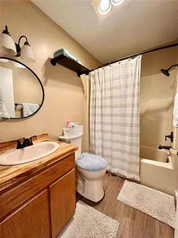 a view of a patio with table and chairs and couches with wooden floor