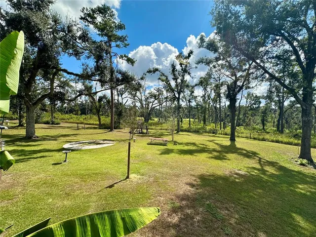a view of a house with a yard and a garden
