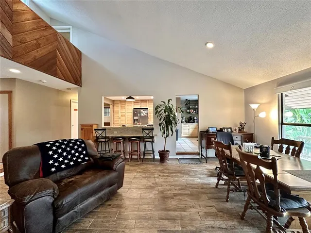 a living room with furniture a lamp and a dining table