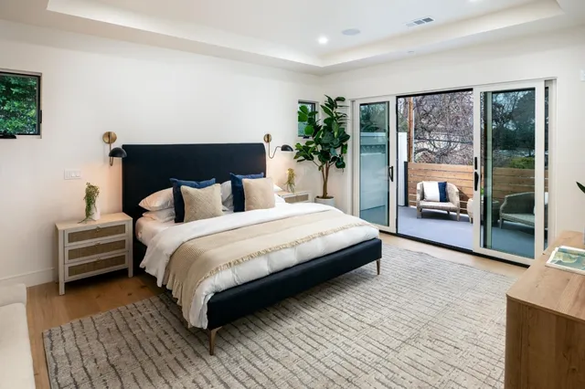 a bedroom with a large bed and a large window