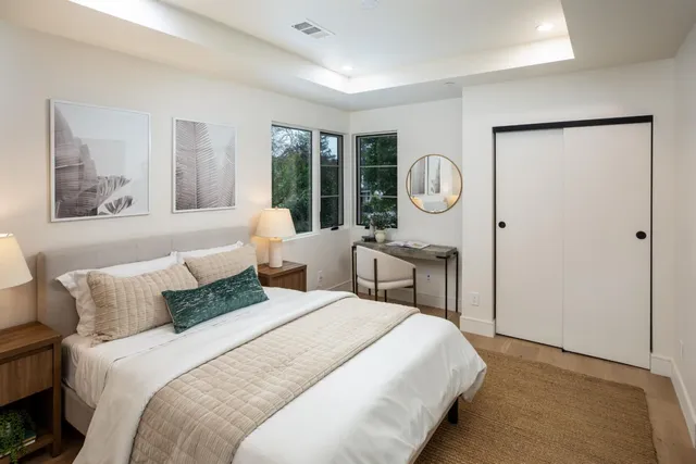 a bedroom with bed and a large window