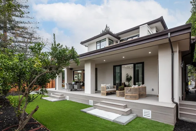 a view of a house with sitting area and garden