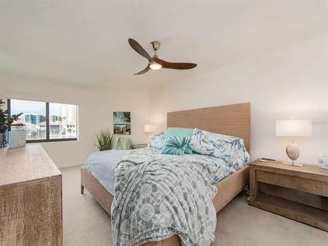 a bedroom with a bed and a large window