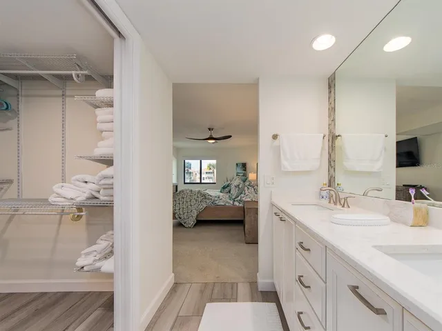 a en suite bathroom with a double vanity sink a mirror and a shower