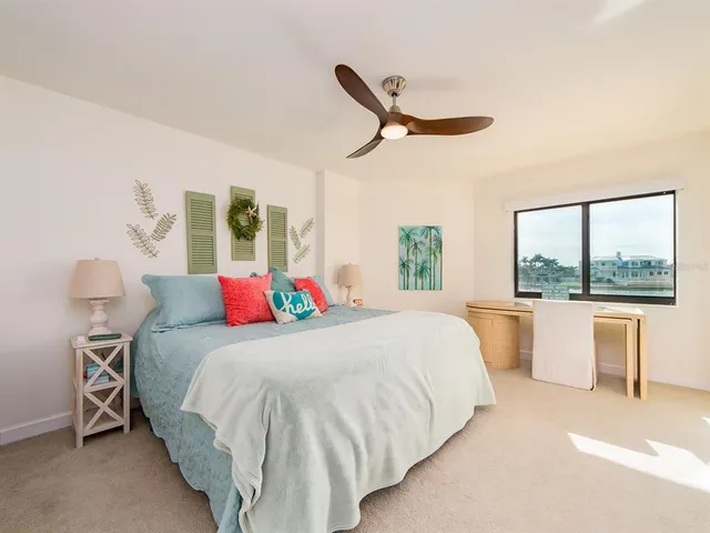 a bedroom with a large bed and a large window