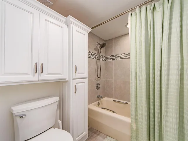 a bathroom with a toilet a sink and a shower