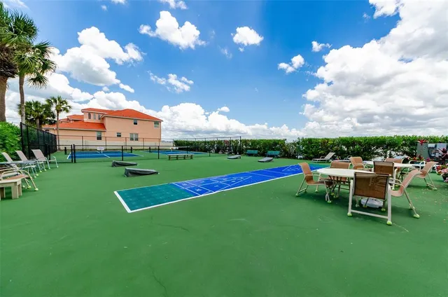 a view of swimming pool with outdoor seating and lake
