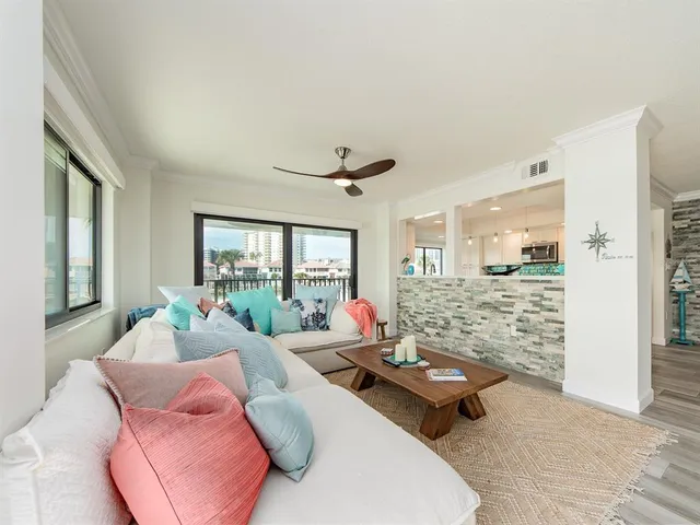 a living room with furniture and large windows