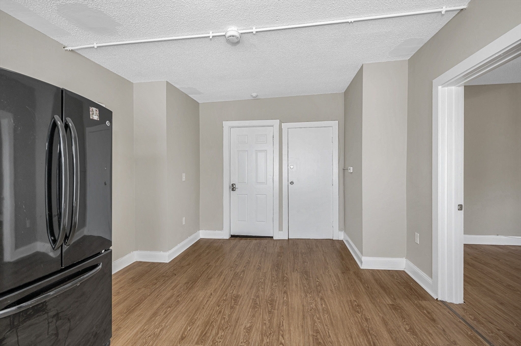 50 1/2 Common Street, Unit 5 Lawrence, MA 01840 - Photo 7 of 18 a view of a room with wooden floor and a window