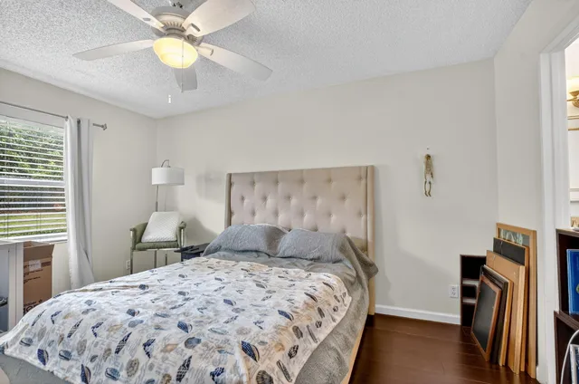 a bathroom with a granite countertop sink mirror vanity and toilet