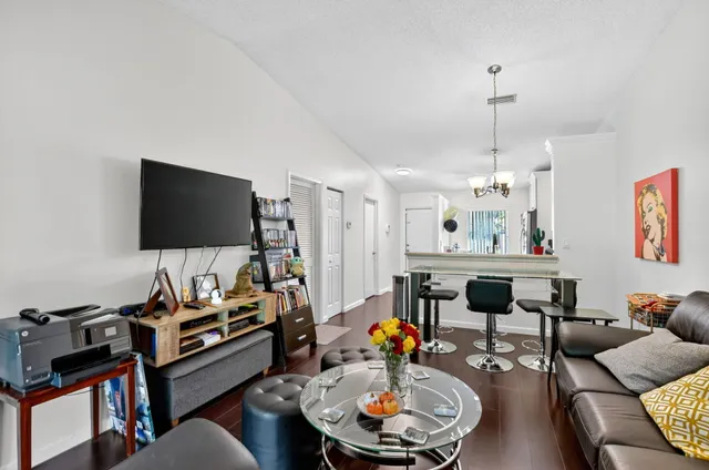 a bedroom with furniture and a large window