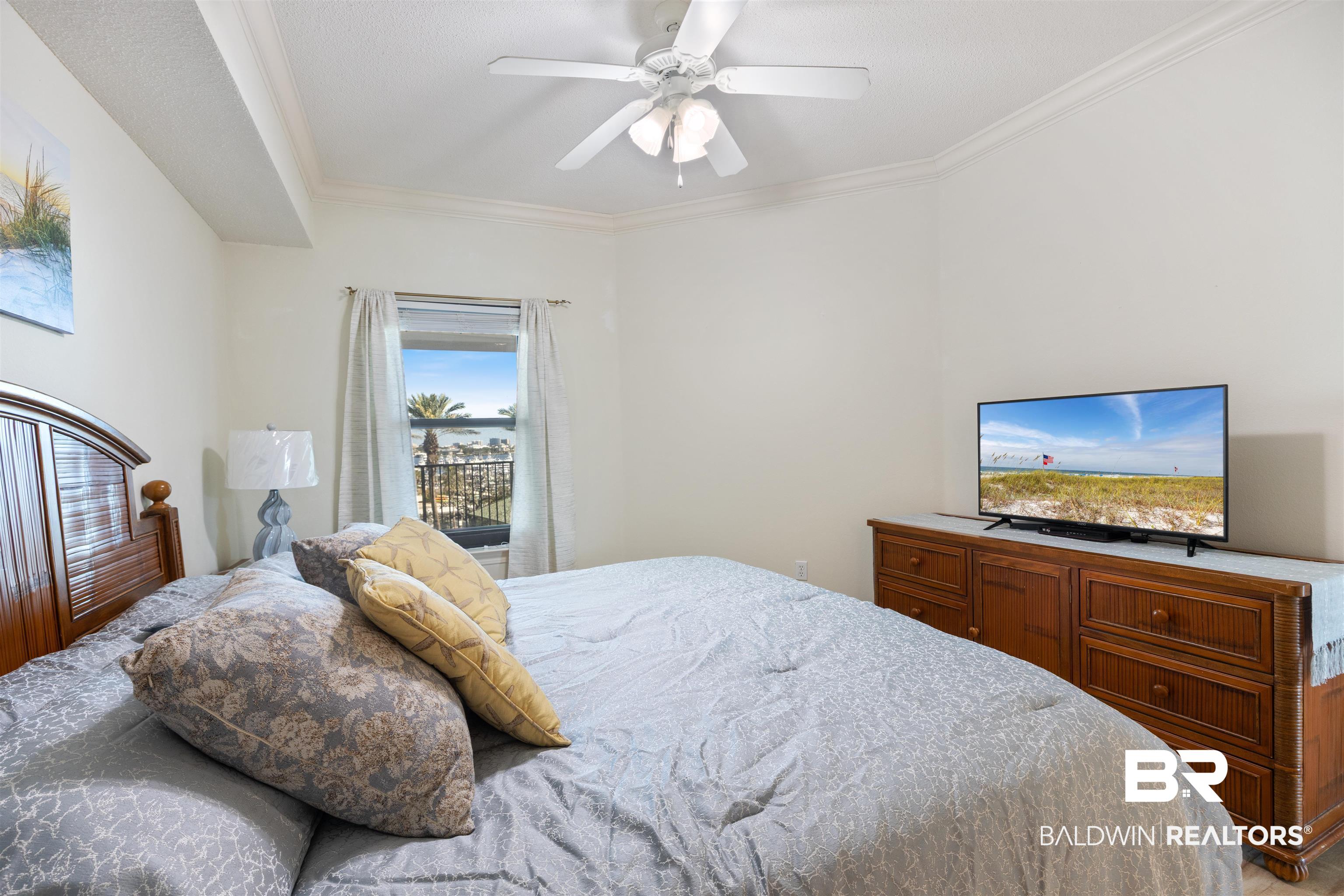 27580 Canal Road, Unit 1431 Orange Beach, AL 36561 - Photo 21 of 73 Bedroom with ornamental molding and a ceiling fan