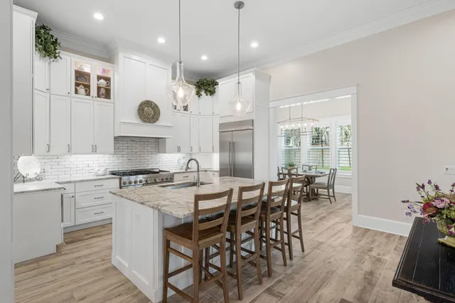 a spacious bedroom with a bed and wooden floor