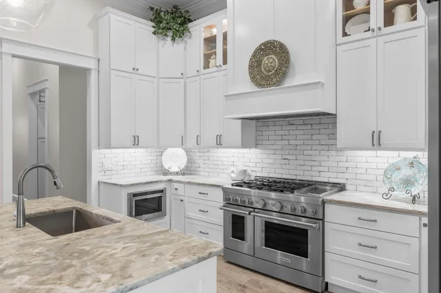 a spacious bathroom with a double vanity sink a mirror and a bathtub